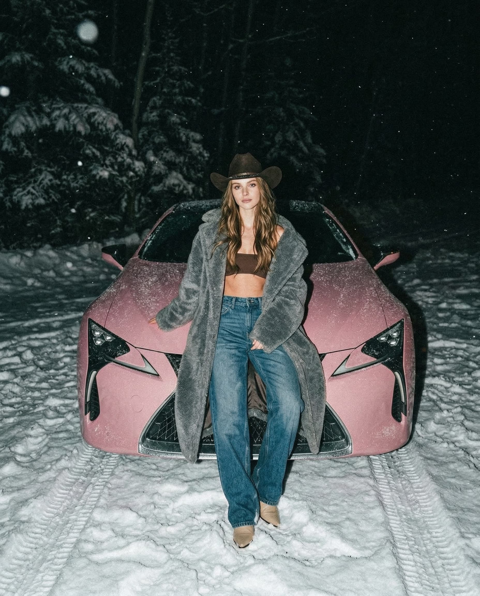 A straight-on medium shot captures the woman leaning against the frost-covered Lexus LC 500 in a wintry landscape. She wears a dark brown cowboy hat, a fuzzy, oversized gray coat, a brown bandeau top, loose blue jeans, and beige pointed-toe shoes. Her long hair falls over her shoulders. The Lexus is coated in a layer of frost, and the background features trees covered in a dusting of snow. The lighting is the same as the Lexus location. The color palette is nearly swallowed by darkness, dominated by near-black charcoals. Cinematic atmosphere where the rustic elements feel heavy, shadowed, and quietly ominous.
HEX VALUES: ["#1a1a1b", "#222224", "#141416", "#0d0e12", "#2f2c28", "#05060a",
"#3a3936", "#6a6b6a", "#4f5654", "#5e6362", "#484b48", "#3e2b25", "#5a433a"]
The Lexus LC 500 has a length of approximately 4,770 mm, a width of 1,920 mm, and a height of 1,345 to 1,350 mm. Its wheelbase measures 2,870 mm.

Ultra realistic, highly aesthetic Y2K, ultra-dreamy nostalgic early-2000s vibe.