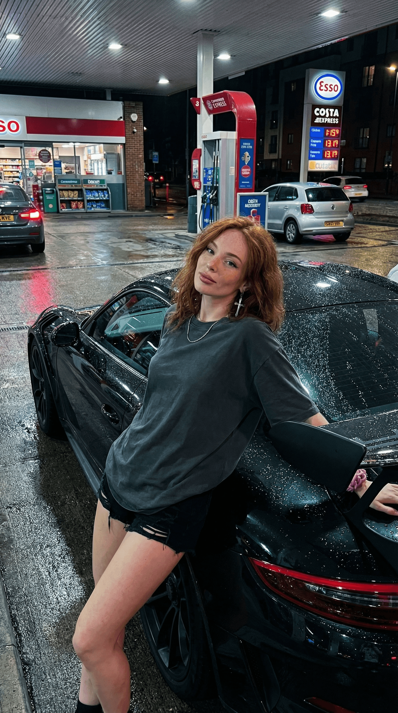 Generate an ultra-realistic portrait and photograph of the person from the reference selfie, positioned as shown in the provided image. They are leaning against a black Porsche GT3 RS at a gas station in USA at night.
Face accuracy 100%. The scene captures the ambiance of a gas station in england at night, with the ground appearing wet and reflecting the colorful urban lights and signs The background includes typical gas station elements and a building with signs. The image should have ultra-realistic and detailed cinematic quality, as if captured by an iPhone 17 Pro Max, with natural proportions and realistic textures.
The overall color grading should be dark and moody, reflecting the night scene, with vibrant reflections from the artificial lights.
(Style: ultra-realistic detailed hyper, 8k, cinematic night lighting, HDR cinematic sharpness, iPhone 17 Pro Max photo)